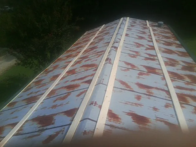 Rusted metal roof panels with new wood purlins before replacement — Storm Damage Roof Repair in Mullins by Roofing Brothers